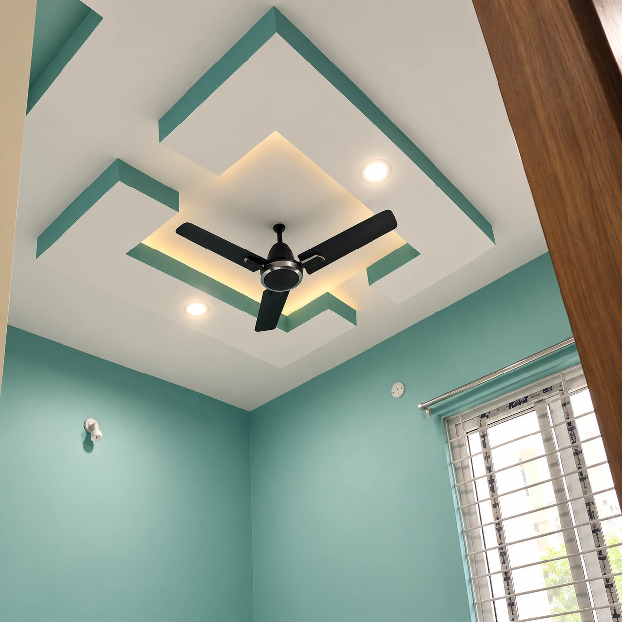 Teal room with geometric false ceiling